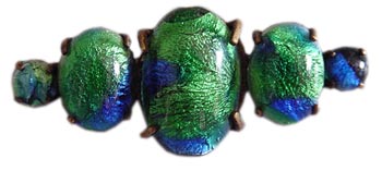 This Edwardian era brooch from about 1915 features peacock-eye glass cabochons.