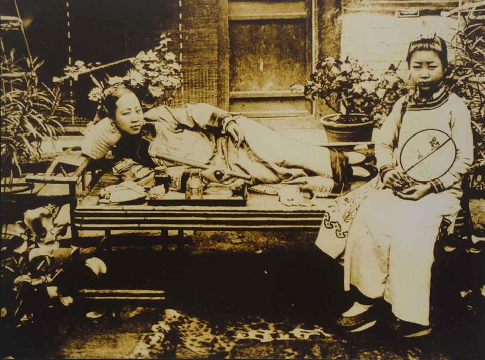 Women smoking opium in China, circa 1900.