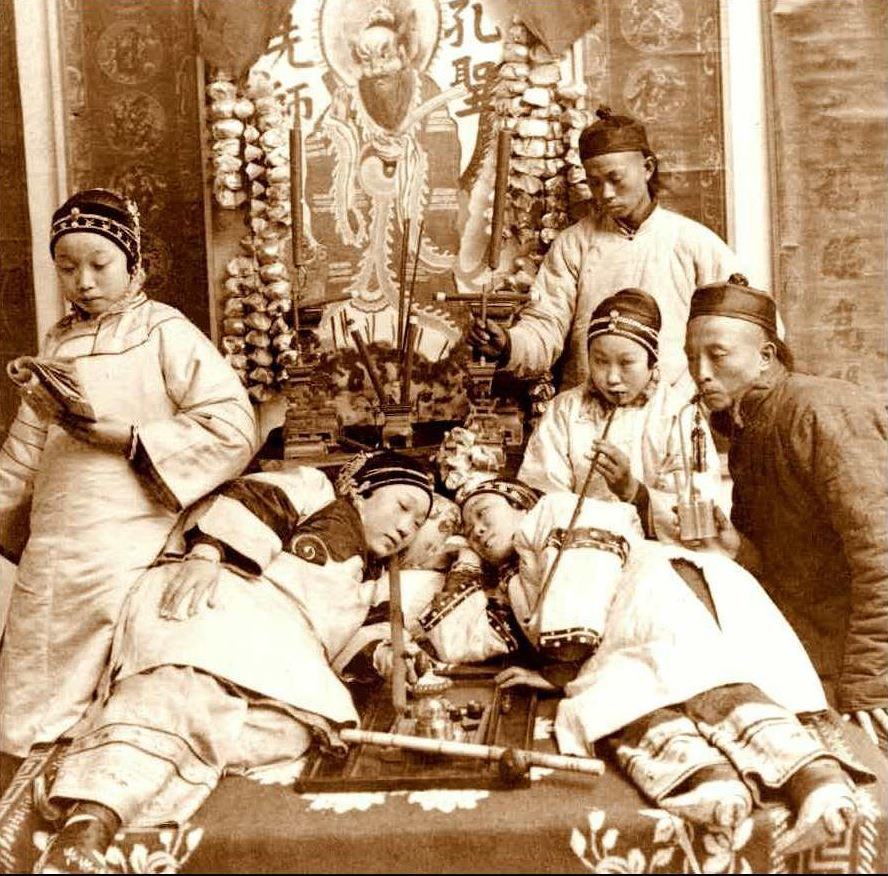 This photo depicting opium smoking was posed in a studio for a stereoview card, circa 1900. 