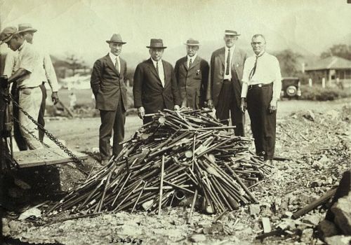 Confiscated opium pipes in Hawaii are piled up and readied for burning in this photo, circa 1920.