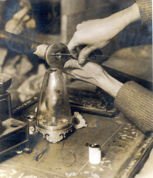 A rare close-up photograph of an opium smoker preparing a 