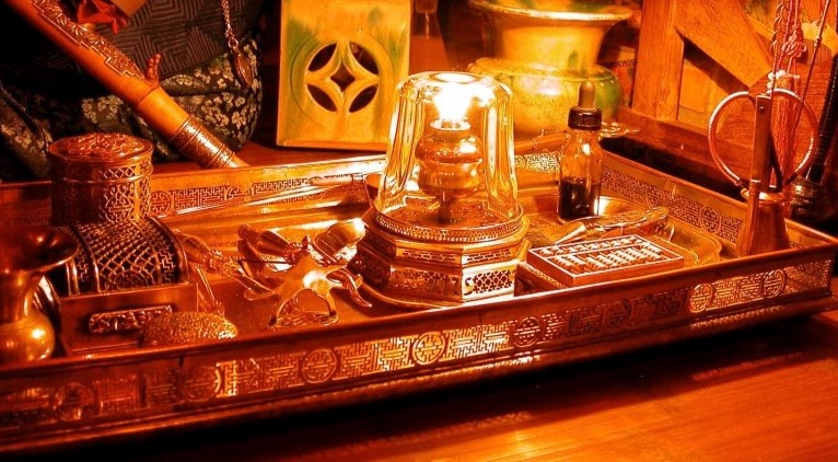 An example of an opium tray and accoutrements. The metalwork is designed to reflect the lamp light. 