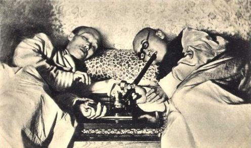 Two opium smokers in a Shanghai, China, den in the early 20th century. 