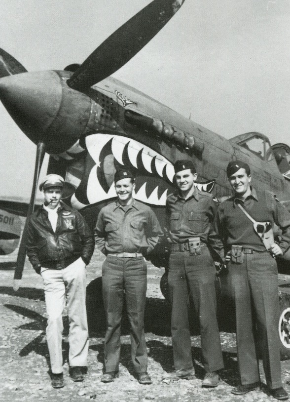 Top: Staff Sgt. Cyril Dworak, an air gunner, had a fellow airman in the 96th Bomb Group, Joe Bodner, paint his jacket. The swastika denotes a victory over a German fighter plane. Above: Officers of the 23rd Fighter Group pose with their "Shark Mouth" P-40. From the collection of John Campbell. 