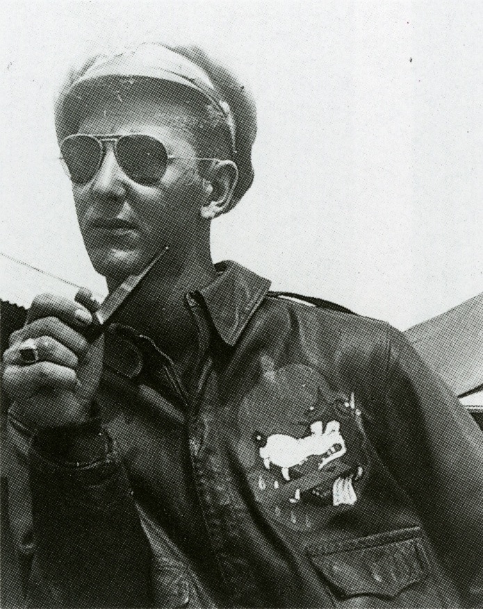 Flight officer Robert J. Meer in Lipa, Philippines, with the "Glider Wolf" insignia of the 1st Glider Provisional Group painted on the front of his A-2. 