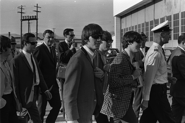 The Beatles and their manager, Brian Epstein (at left, in sunglasses and white shirt), arrive in Vancouver, B.C., 1964. Photo: Deni Eagland/Vancouver Sun PNG Merlin Archive.