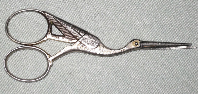 Expectant mothers often used stork-shaped objects like these embroidery scissors. Stork-shaped clamps were even used to cut umbilical cords.