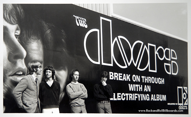 The Doors posing against their 1967 billboard, which supposedly started the trend. Courtesy of Clear Channel Outdoor Archives.