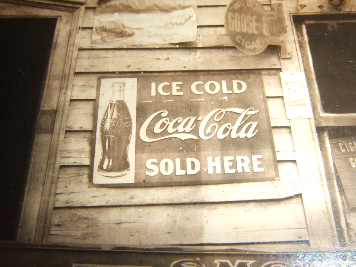 Photograph with early Coca- Cola advertising