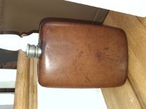 A couple old hip flasks left in grandmothers cabinet and a camera