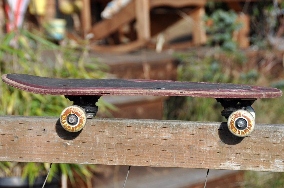 Very old skateboard made of laminated wood