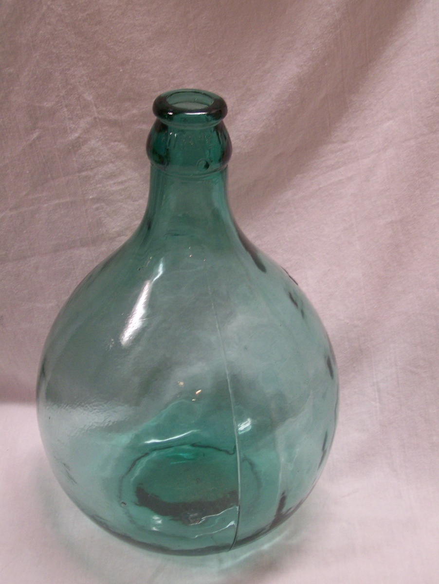 Large blue glass jug bubbles in glass - Bottles