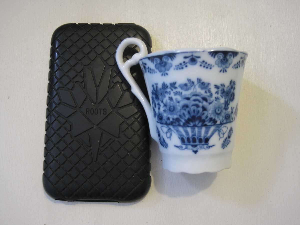 Diminutive blue and white cup with distinctive handle