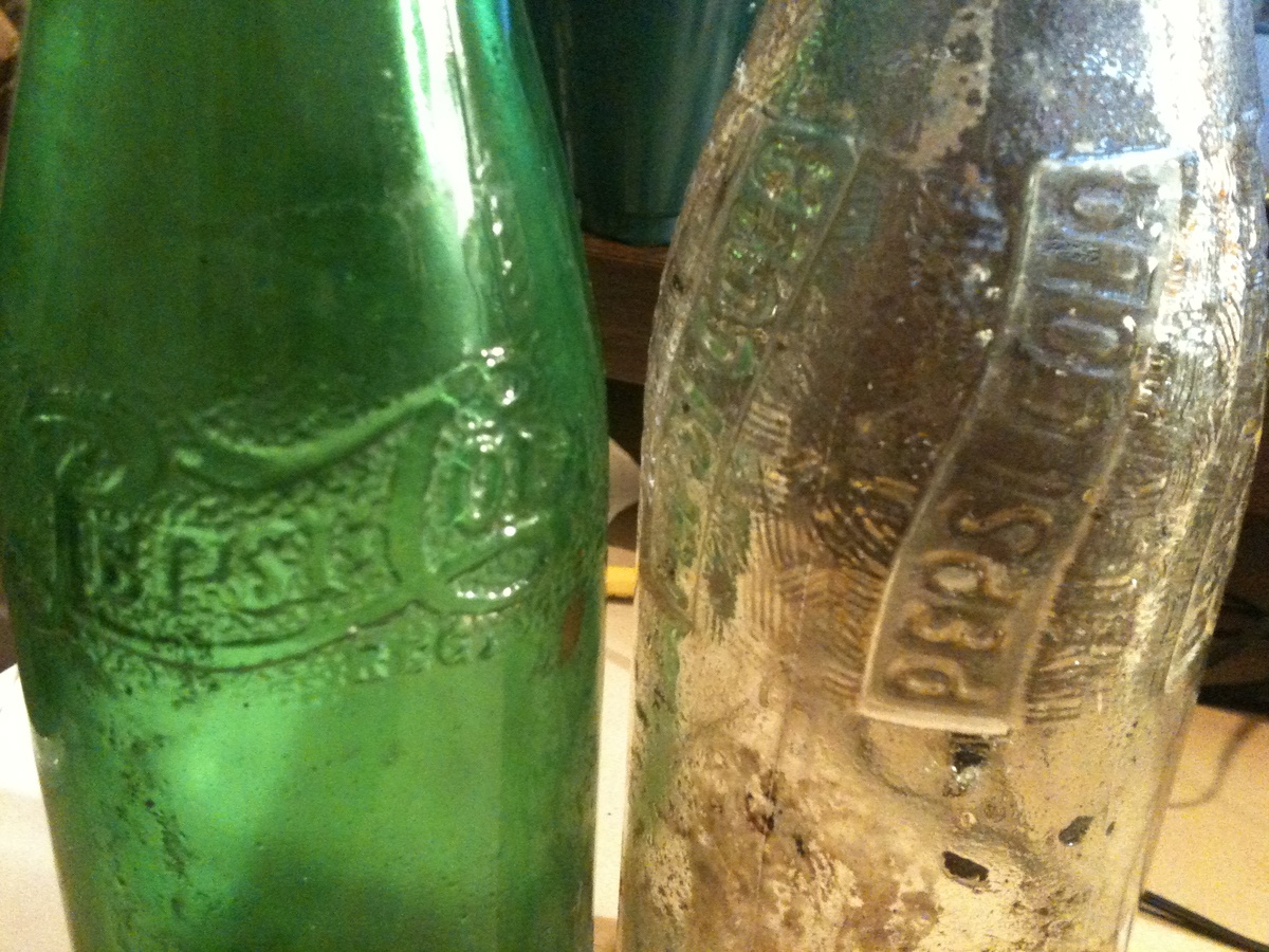 old green pepsi bottle and clear pepsi bottle
