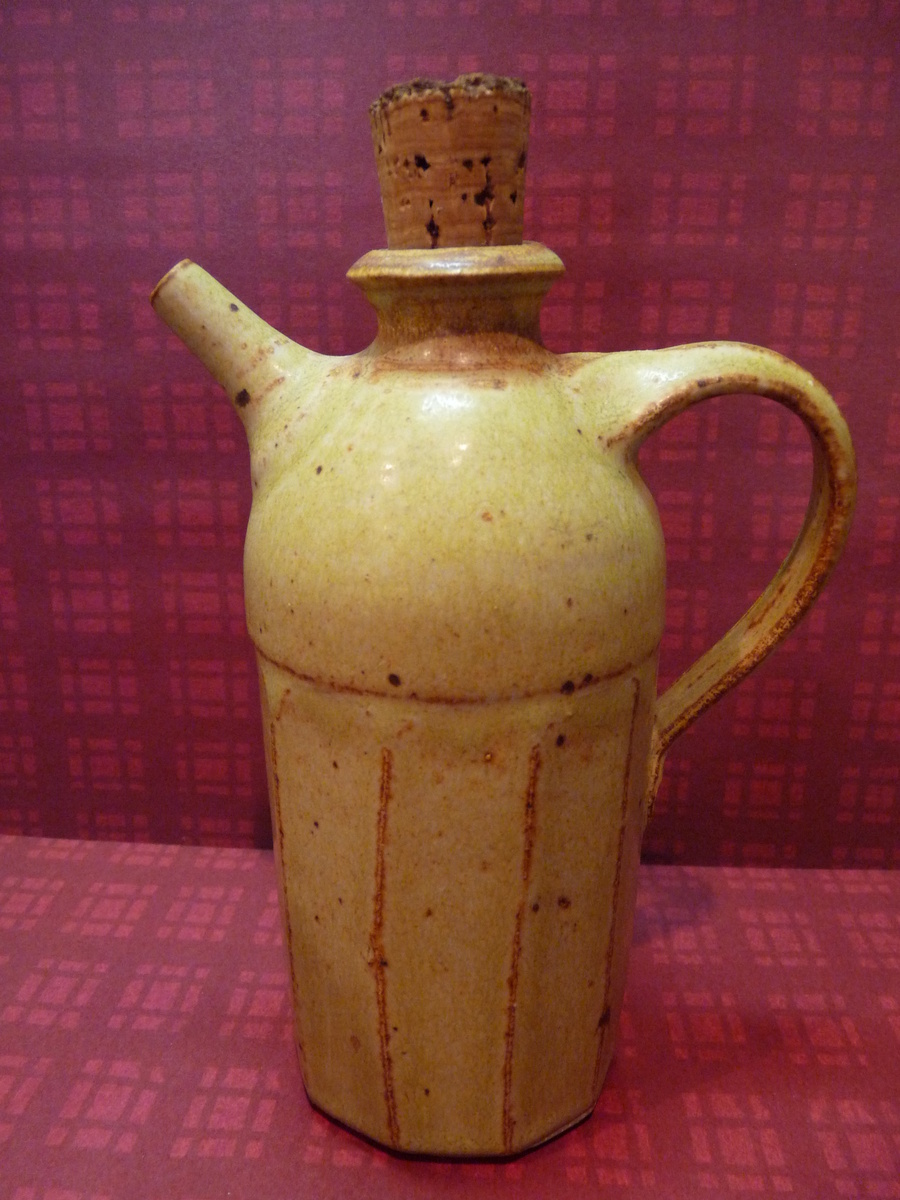 ceramic jug with cork stopper and a spout