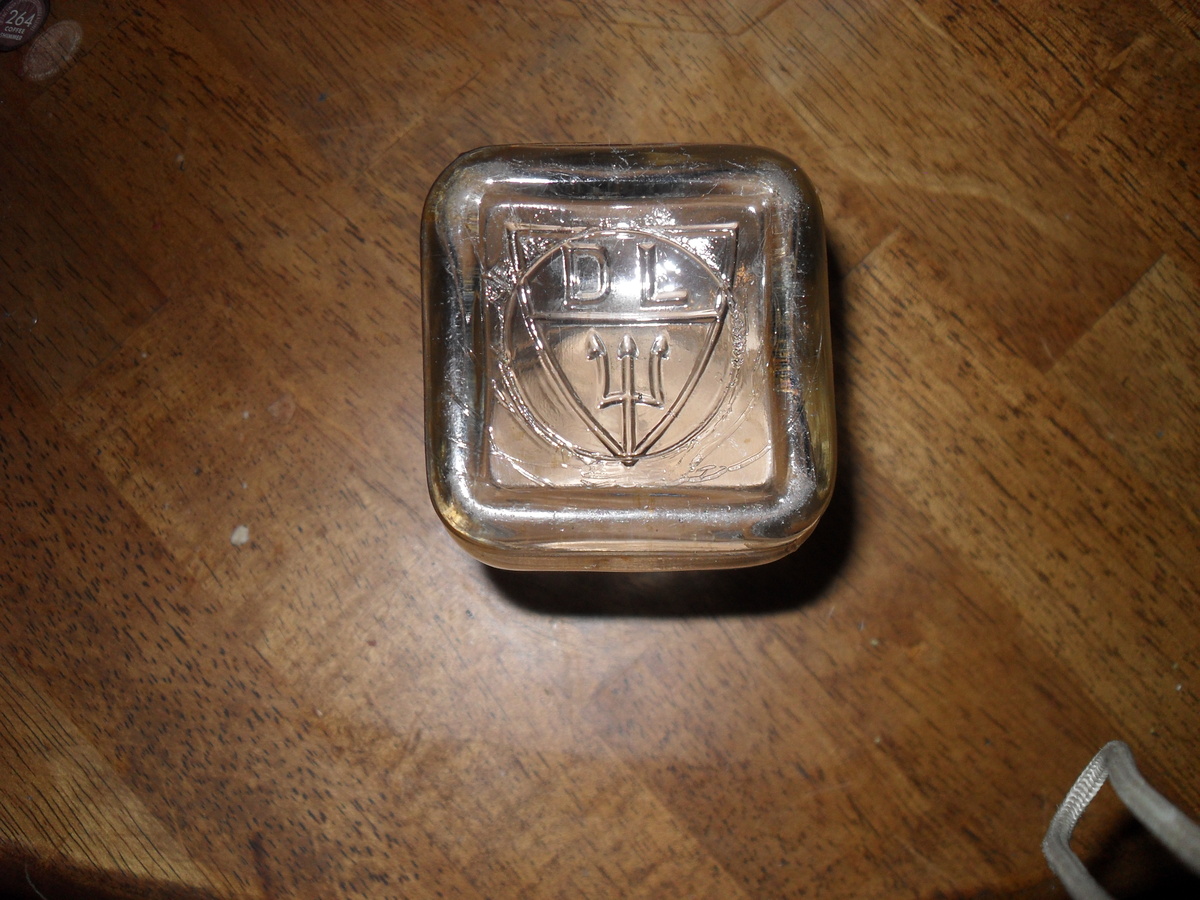 Small Glass jar with embossing on the bottom? - Bottles