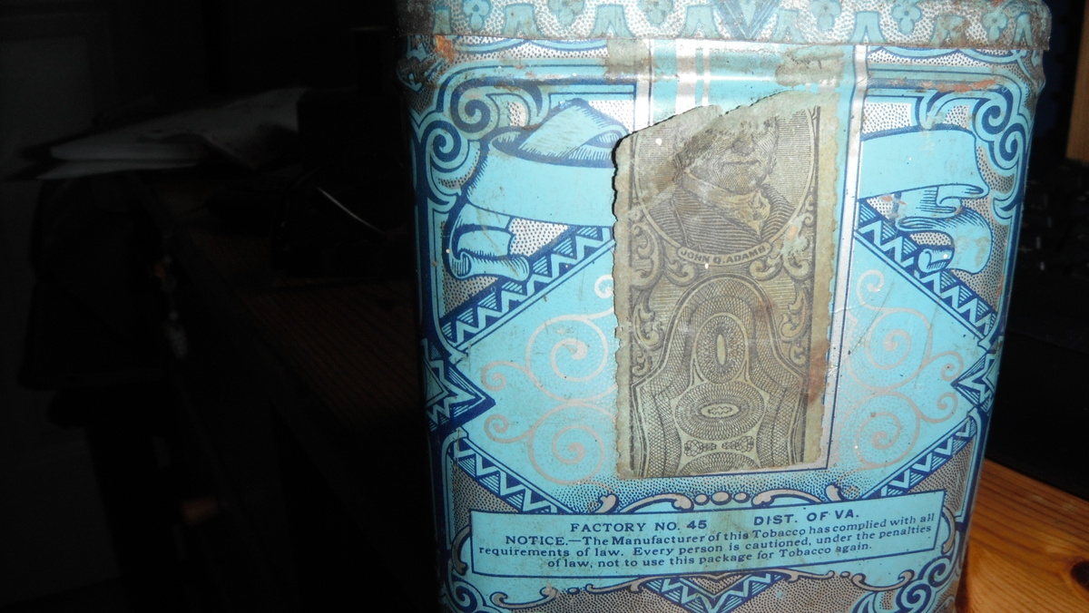 Tobacco tin with John Q. Adams strap and 2 stamps on the bottom
