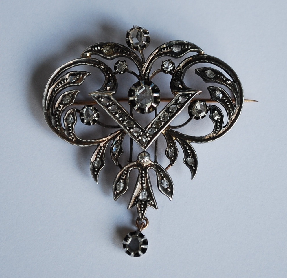 From what Era is this brooch and how I can detect silver of white gold?