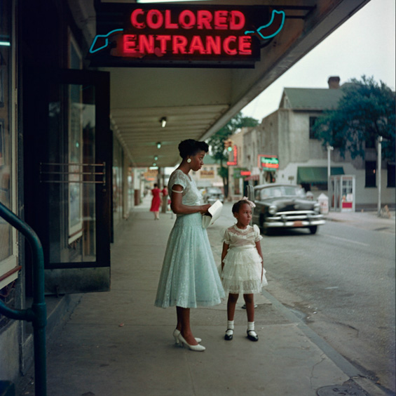A woman and her niece wait outside the "colored entrance" to a movie theater in Selma, Alabama, in 1956, as documented by Gordon Parks. Courtesy of the <a href="http://www.gordonparksfoundation.org/">Gordon Parks Foundation</a>.