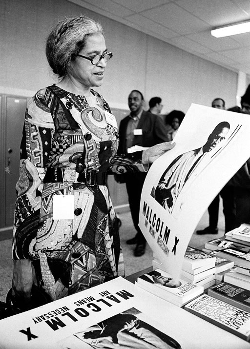 LeRoy Henderson photographed Rosa Parks with a Malcolm X poster at the first National Black Political Convention in 1972. Courtesy <a href="http://www.leroyhenderson.com/Welcome.html">LeRoy Henderson</a>.